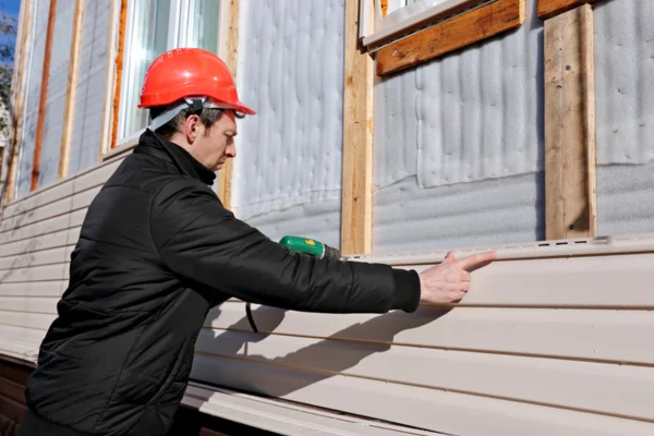 Male Contractor Installing Energy Efficient Sidings in Denver CO