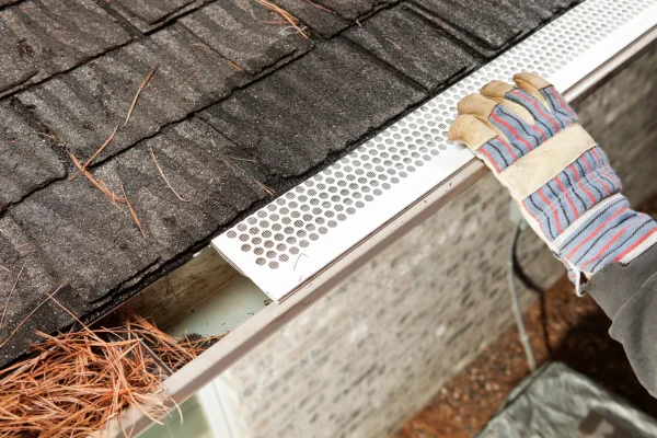 Roofing Contractor Installing Leaf Guard Gutter System in Denver CO - The Install Company