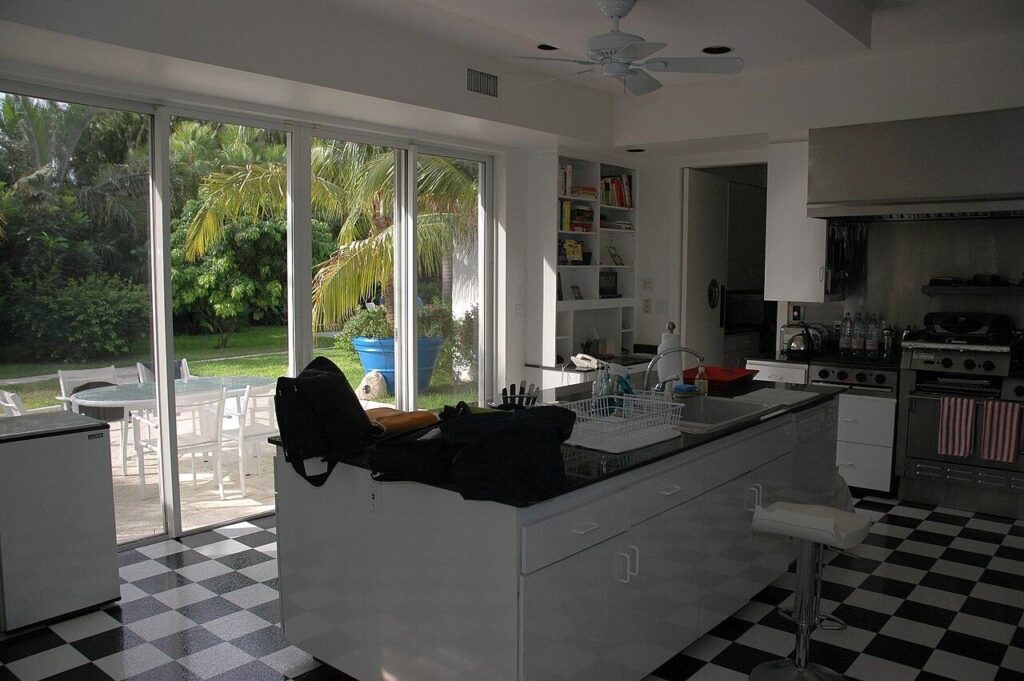 Sliding glass doors connecting a kitchen to the backyard patio